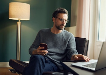 Middle aged man looking at computer evening