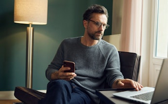 Middle aged man looking at computer evening