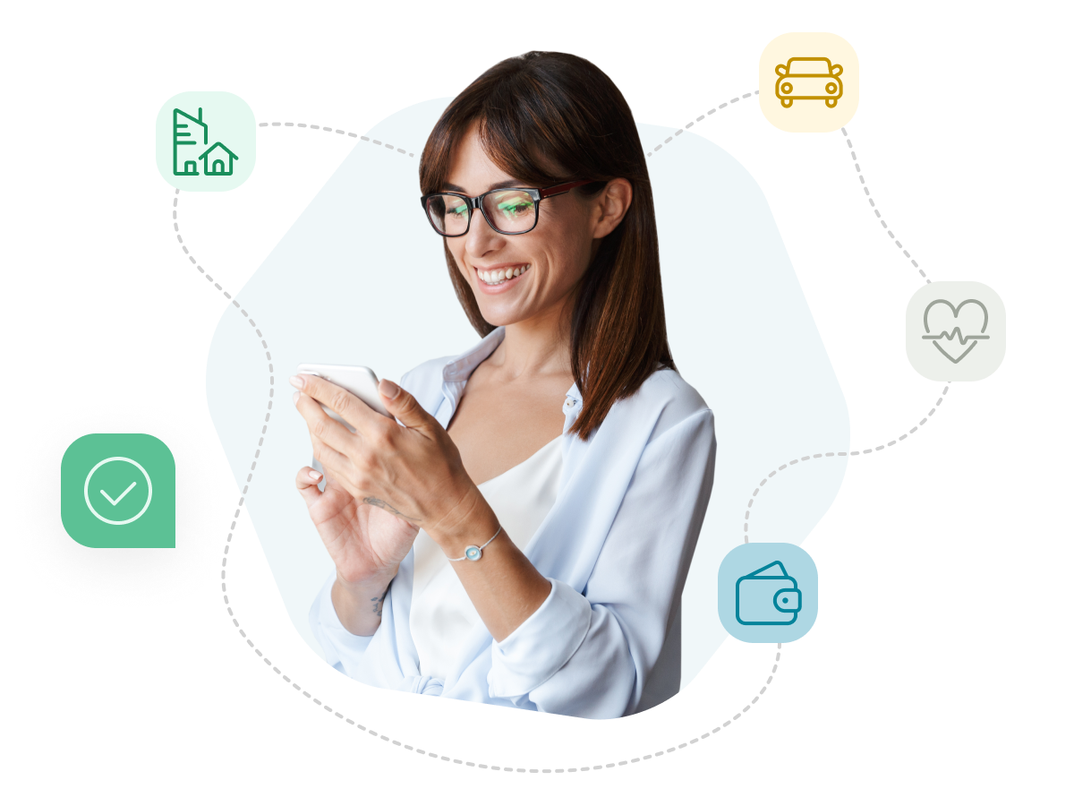 A woman wearing glasses, standing, holding her phone in two hands and looking at it